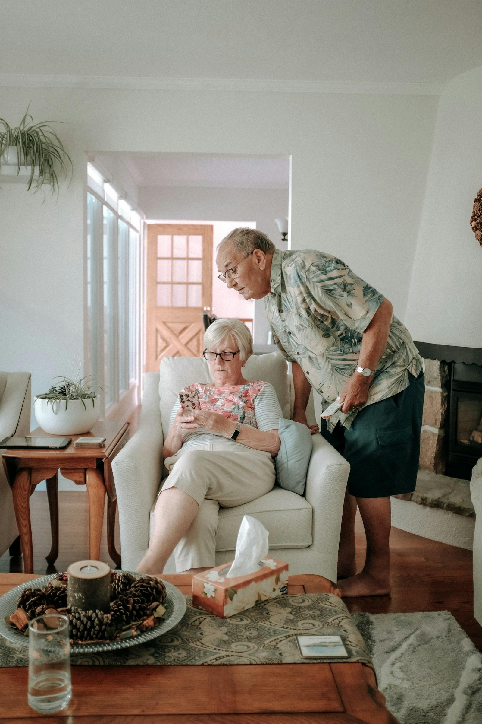 A caregiver and a senior sharing the morning in a sunlit room